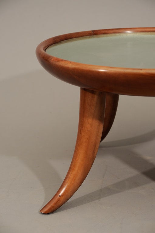 Rare and exquisite low table by Italian architect Guglielmo Ulrich. The four legs showing an extraordinary curve inspired by ancient times. Carved and polished pear wood with silver leaf top under glass. <br />
Literature: Guglielmo Ulrich, Ugo La