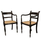 A Pair of Colonial Ebony Arm Chairs