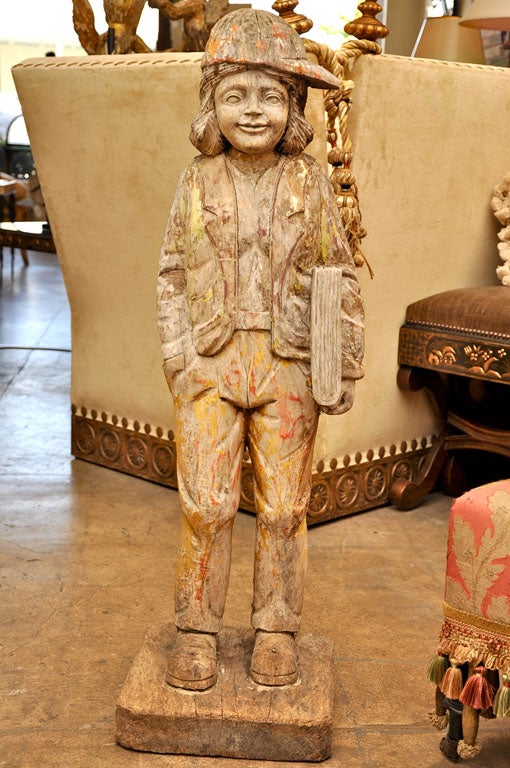 Rare wood carving of child holding a book.