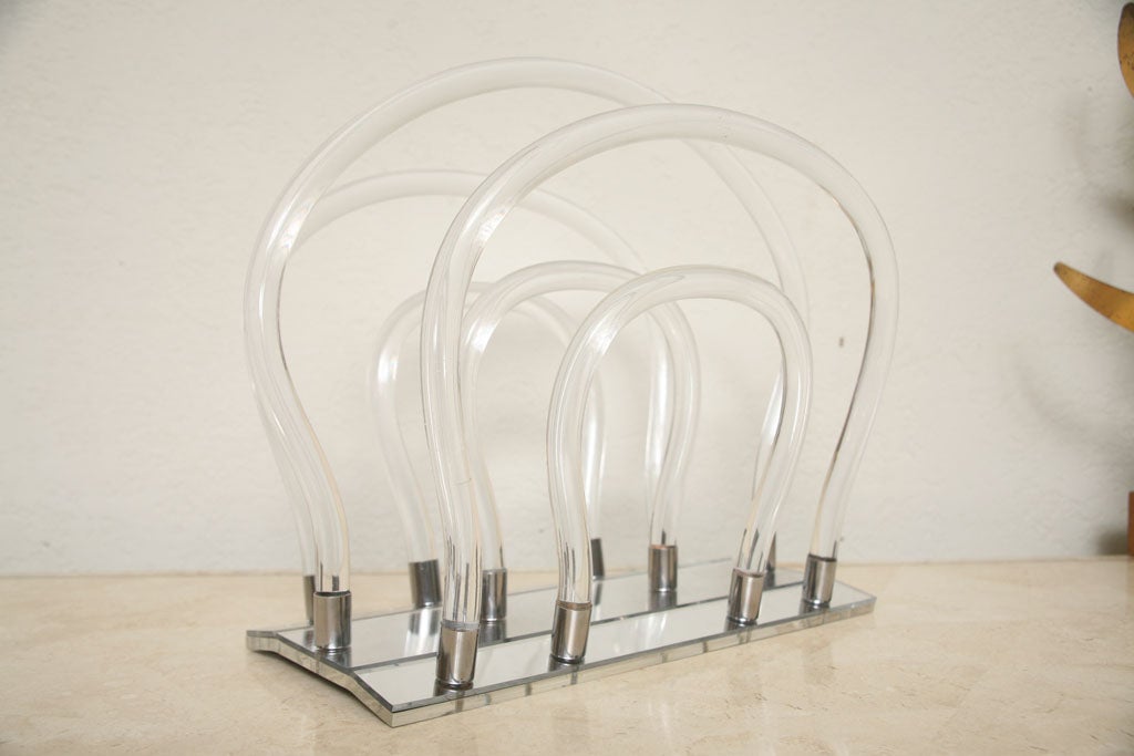 In this Dorothy Thorpe design, six lucite loops combine to hold your magazines in mid-century style.