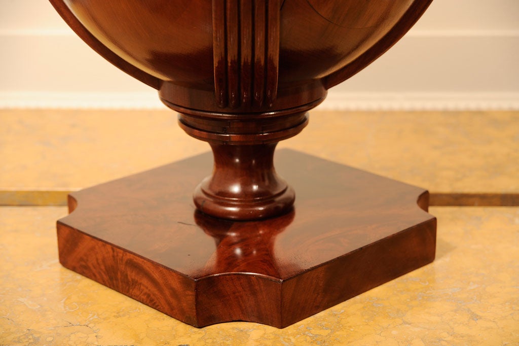 Each surmounted by a later oval finial with reeded sides, raised on a molded socle above the upper reeded section terminating in a square border with circular re-entrant corners, the upper section lifting off to reveal circular steps pierced for