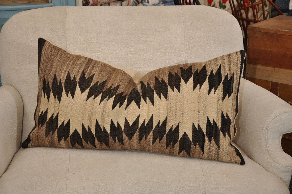 EARLY 20TH C. NAVAJO INDIAN WEAVING EYEDAZZLER PILLOW WITH TAN, DARK BROWN AND CREAM COLORS. FRONT IS NAVAJO WOOL. THE BACKING IS LINEN. DOWN FEATHER INSERT.