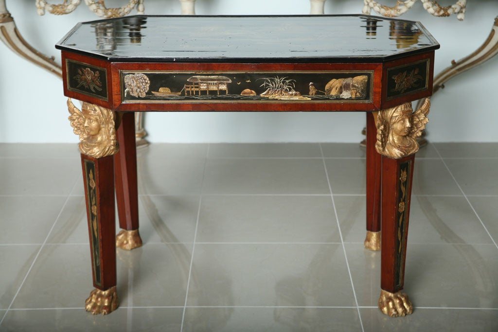 Possibly Russian- The chinoiserie decorated octagonal removable tray top over a frieze with chinoiserie decorated lozenges framed with brass trim, resting on winged Egyptian caryatid terms over square tapering legs similarly decorated terminating on
