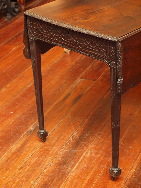 Exceptional English 18th C. Pembroke Table with shaped leaves and fretwork carving on original casters and untouched finish.