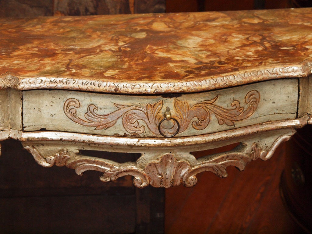 Painted and silver gilt console with one drawer and faux marble top. This Piece has Always been painted and is not one the the recently painted old pieces of furniture. It is amazing