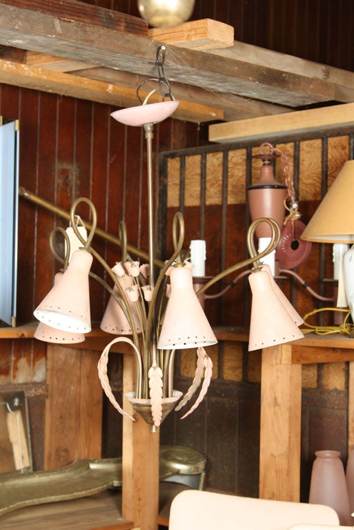 A fanciful pink painted metal and brass floral style chandelier with 6 cone shaped shades, 1950s-1960s.