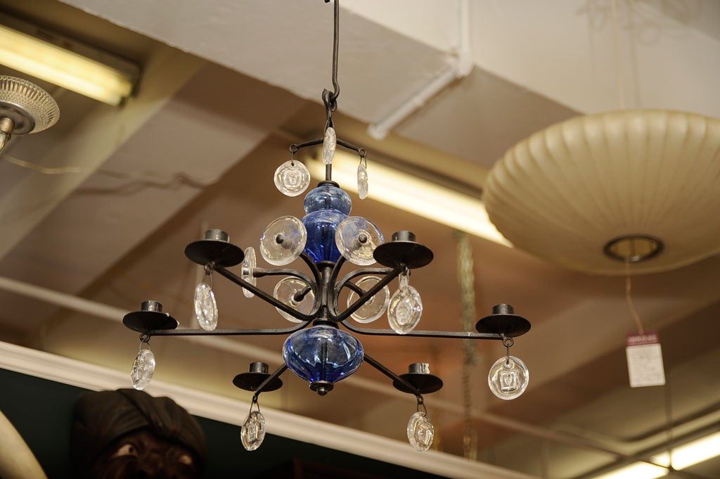 Swedish wrought iron and hand blown glass candelabra ceiling fixture designed by Erik Hoglund for Kosta Boda, with six arms. The clear glass pendats feature etched faces. Four wrhought iron 