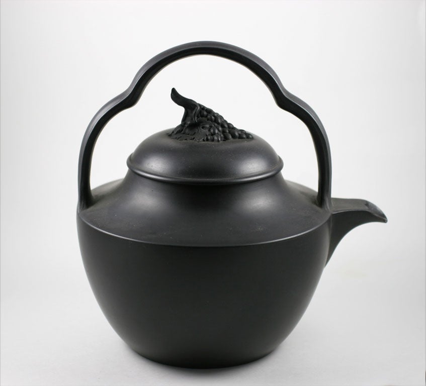 A fine Wedgwood basalt rum kettle with cluster of grapes for finial, upper case mark