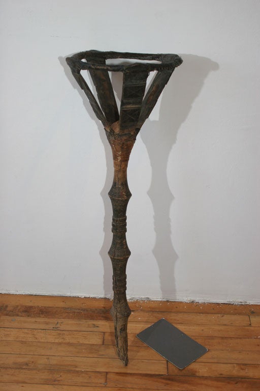 a fantastic hand carved bowl stand, meant to be stuck into the sand of the desert to hold a food bowl for the nomadic Tuareg people of North Africa. intricately carved with traditional designs, and in completely original unrestored condition, this