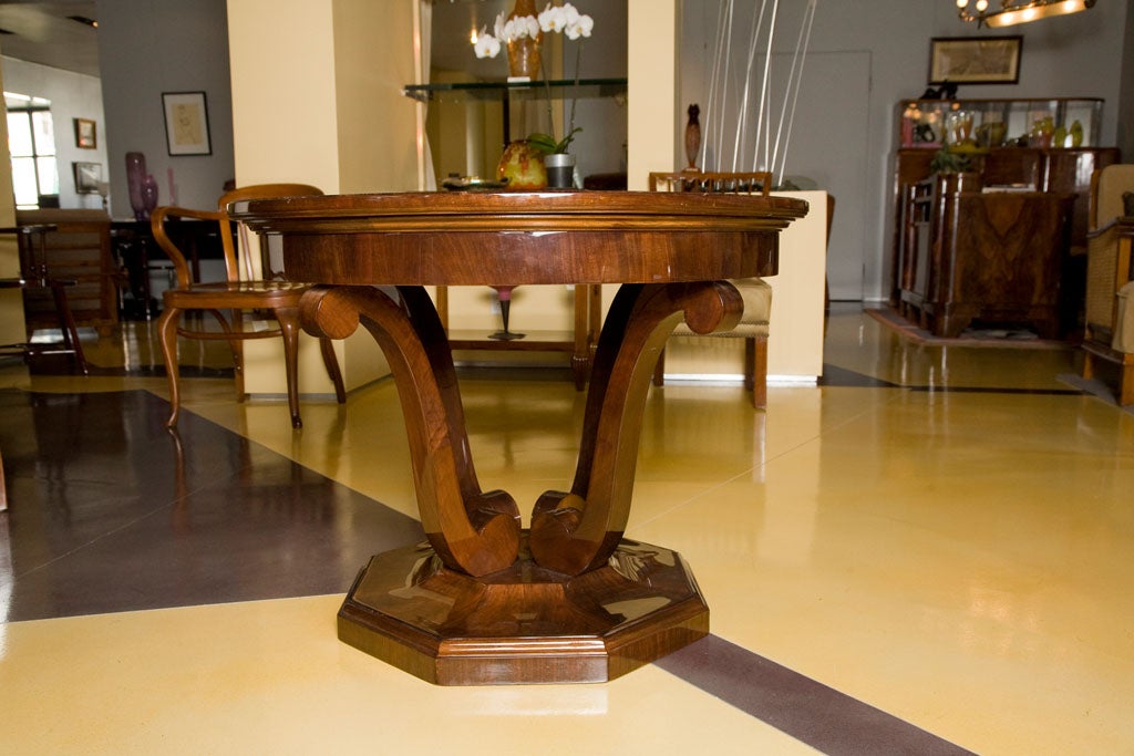Art Deco ocassional table with round top and tulip shapes legs on octagonal base.