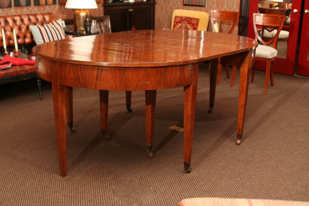 A Biedermeier Walnut Circular Extending Dining Table on Castors and together with Six Leaves<br />
Measurement when extended is 16'<br />
<br />
*NOW ON SALE FOR 30% OFF*<br />
ORIGINALLY $16,000 AND NOW $11,200!!!
