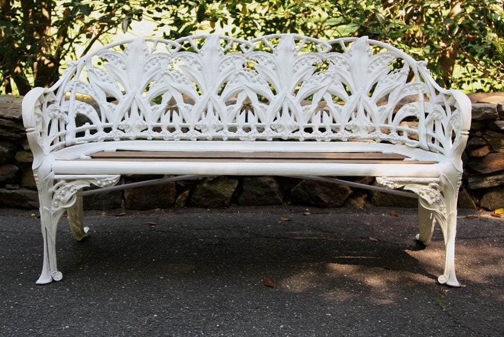 Arched back and sides pierced with lilies-of-the-valley above a wooden slatted seat, on conforming legs, stamped C-B-DALE CO,  and with diamond design patent registration stamp