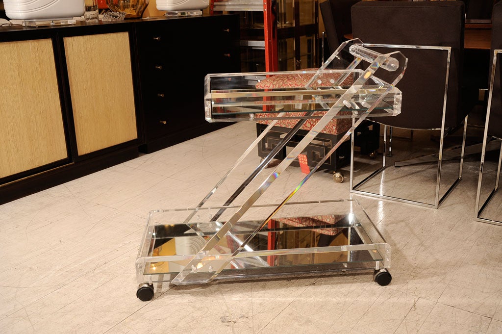 Beautiful Lucite Serving cart with thick, sparkly clear lucite. Glass tray at the top; mirrored tray on the bottom. Located at ABC Carpet & Home, 212-473-3000, ext. 519.