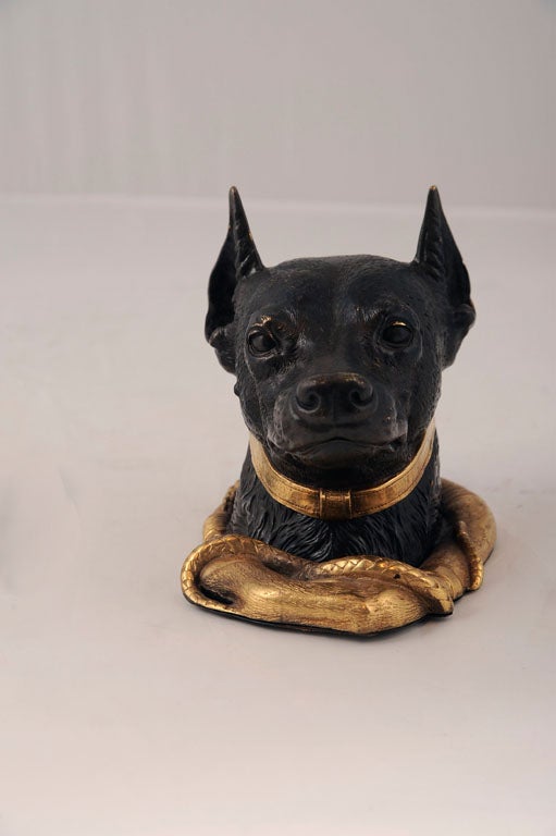 Patinated and gilt bronze inkwell modeled as the head of a Doberman Pinscher