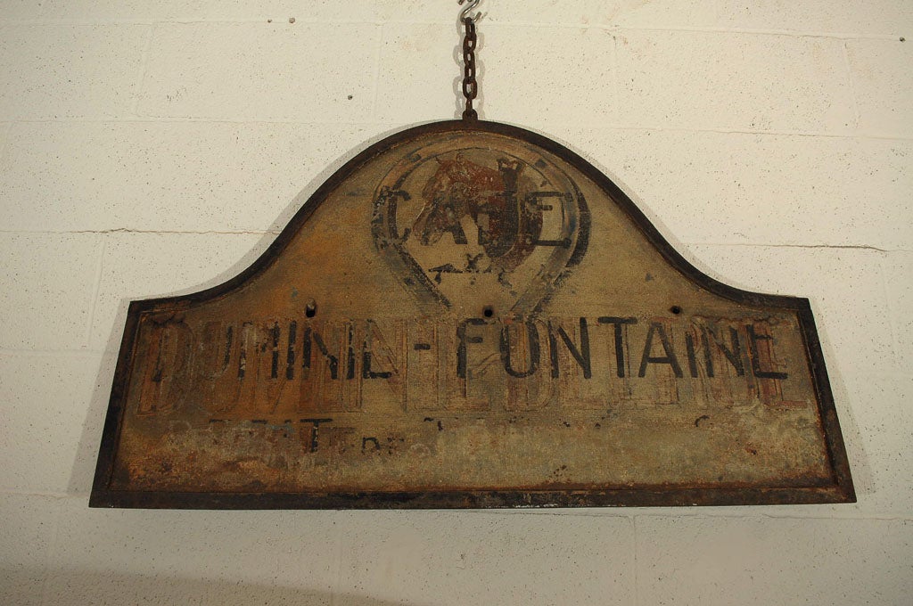 Sign from the Cafe Duminil Fontaine. A wonderful painting of a horse's head above a horseshoe adorns  the sign. There are traces of underpainting giving the sign a beautiful mix of history and color.