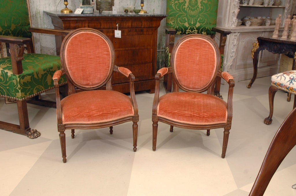 Pair of Late 19th Century Louis XVI Provincial Fruitwood Fauteuils in strie velvet upholstery.

A very beautiful pair of armchairs. 

