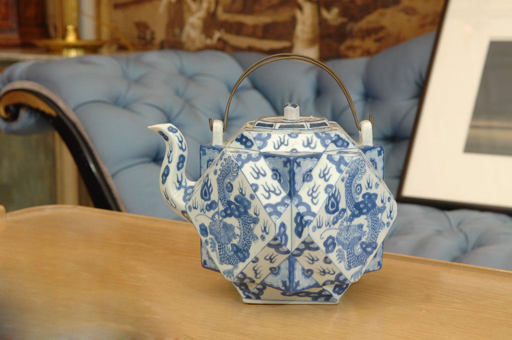 Rare 18th Century Cantonese Tea Pot, <br />
with blue and white decoration in the Chinese taste, depicting dragons and foliate designs, and having an unusual wire handle.