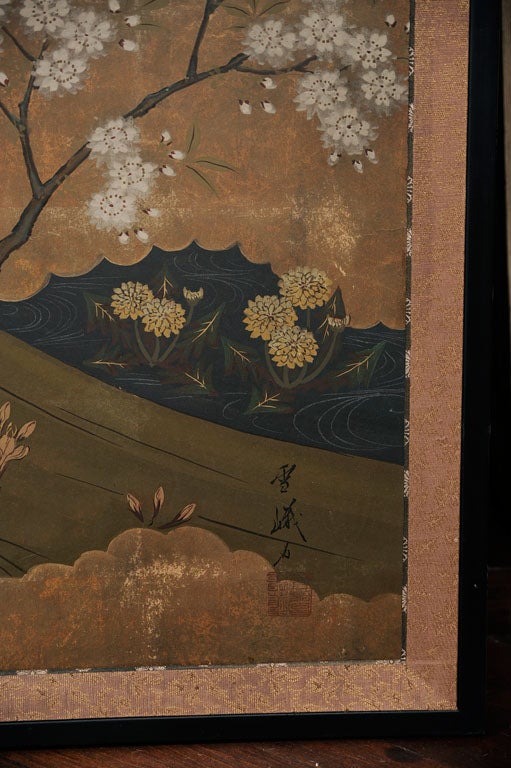 Four panel Japanese screen circa 1930's. Very detailed design of two duck on a hill top with a pond below. The rice paper painting is surrounded by gold leaf. The screen has a traditional fabric brocade border, and a black lacquer frame.