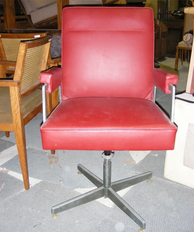 1950s swiveling armchair by Jules Leleu with steel structure and new leather upholstery.