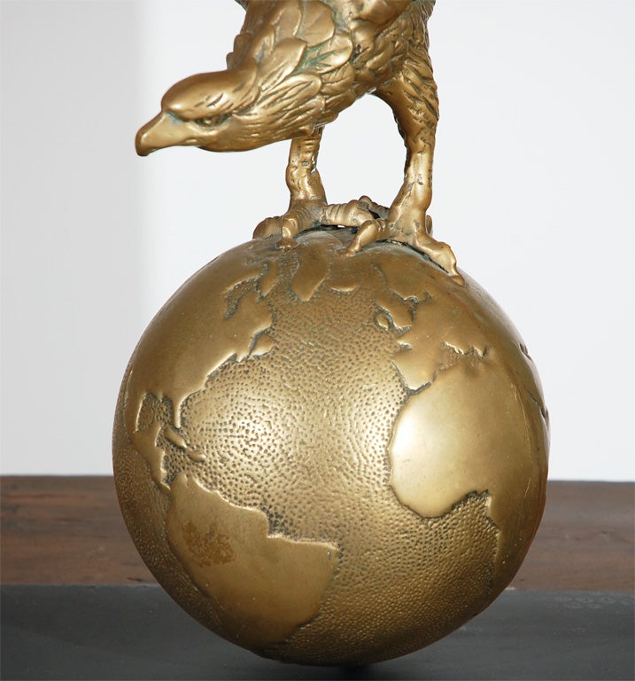 brass eagle on globe