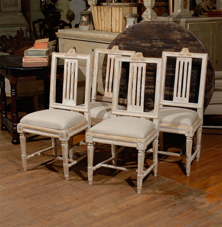 A set of four Swedish period Gustavian side chairs, from the early 19th century with original paint. 

This exquisite set of four Swedish side chairs are typical in many ways of the 
Gustavian period. They feature very clean lines and soft colors