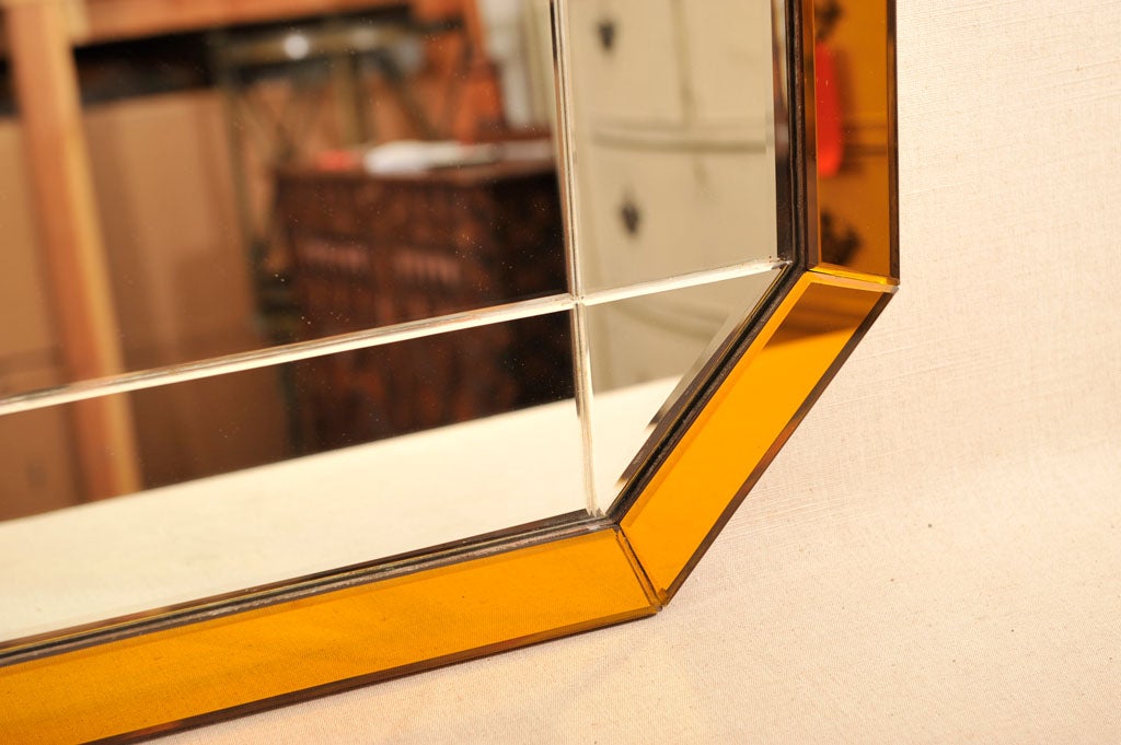 Art Deco Amber Glass Trimmed Octagonal Mirror, England, c. 1930's<br />
<br />
(36 x 24 inches)<br />
<br />
Note: Can Hang Horizontally or Vertically