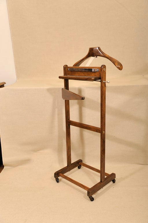 Walnut and Oak Valet Stand with Adjustable Jacket and Trouser Racks All Supported on Four Casters. Maker's Label Inscribed, 