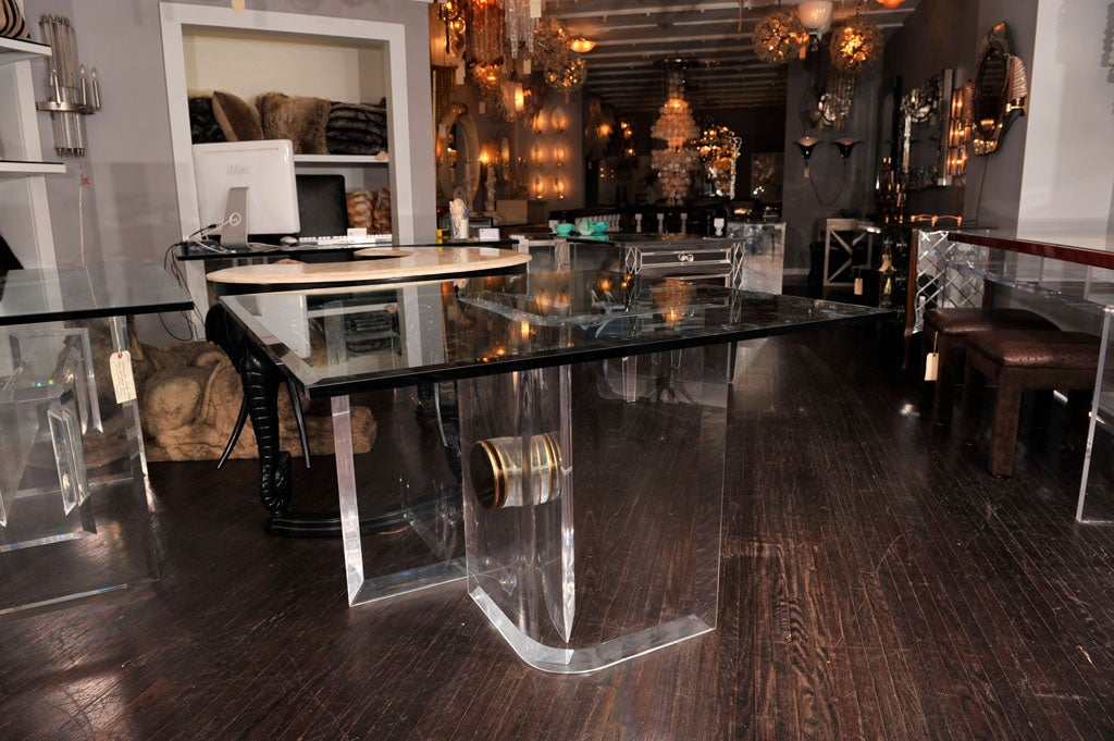 INTERLOCKING LUCITE AND BRASS TABLE BASE WITH A GLASS TOP