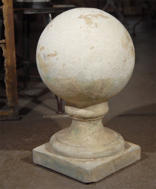 Pair of large cast stone finals.  Large balls atop a molded column on a square base.  Traces of old white paint.