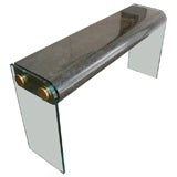 Glass, brass, and bone console table in deep green.