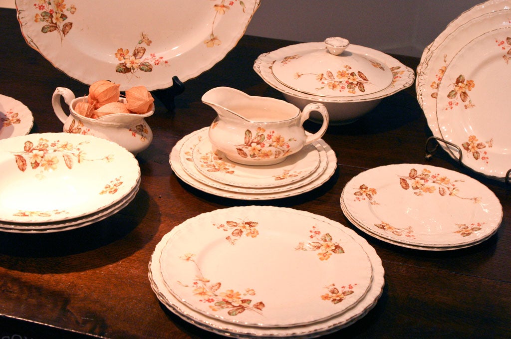 This is a cream colored petal pattern, in a very soft rust color and includes 43 pieces. There is a covered vegetable bowl. Measures: 11, 12.5 and 14 inch platters and 30 plates, in various sizes, with 4 9 inch bowls. There are no cups and saucers,