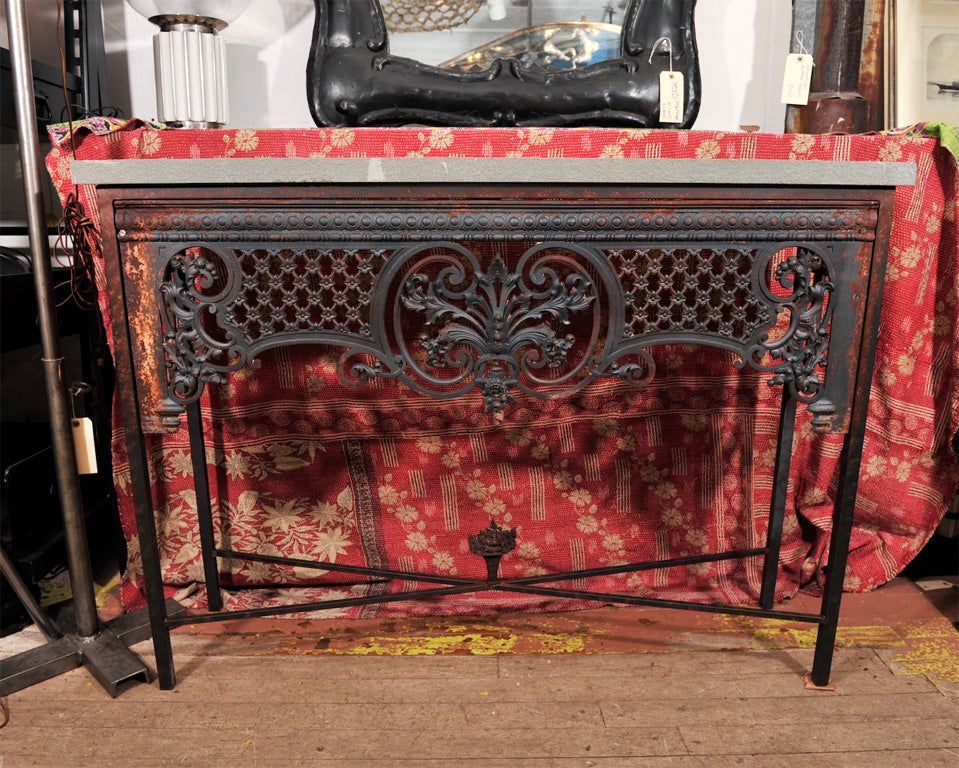 Console table made from repurposed cast iron balcony detail with blue stone top.