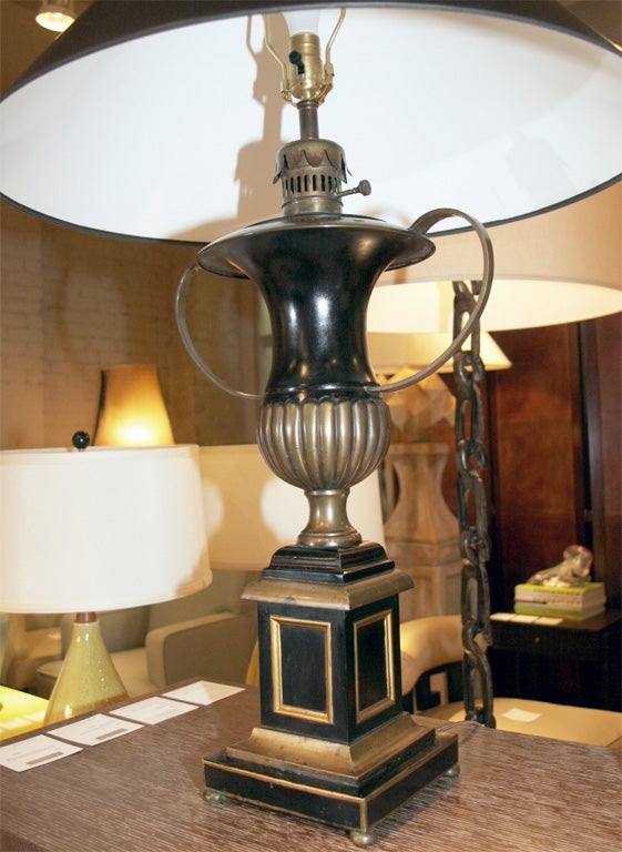Pair of painted black and gold Regency style urn shaped lamps, Italian, circa 1950.