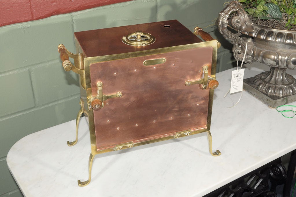 A French autoclave of copper and brass, once used for sterilising medical and dental instruments. Featuring an exterior of copper sheeting with brass hardware including a rotating brass ventilation dial on the top. A latching, hinged door flips down