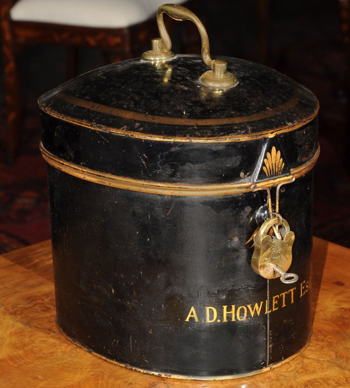 An English barrister’s wig of woven horse hair in original tole box with lock and key, c.1850-1890, featuring a barrister’s wig with accompanying riser, in a fitted black tole box with gold accents and brass swan handle, the exterior marked “A.D.