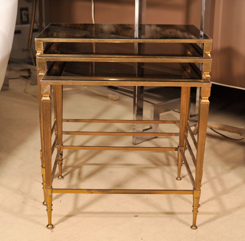 Elegant set of Italian mid-century modern, brass nesting tables in a neoclassic style. Many beautiful details.

Measures: Large W 19 inches x D 14 inches x H 17,25 inches, Medium W 17.25 x D 13.5 x H 16 inches, Small W 15.25 x D 13 inches x H 15