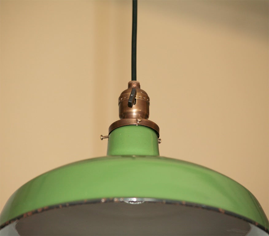 Hooded green enamel pendant fixtures, with soft green hue.  Pricing is per fixture. Complete with complimentary brass ceiling canopy.