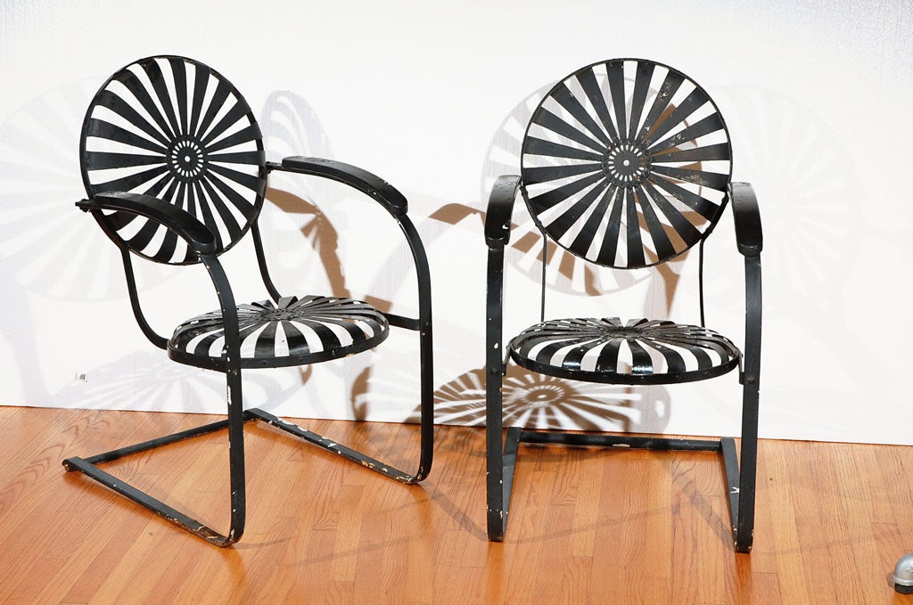 This pair is an evolution of the chairs originally designed by Carre' for the world's fair in 1880, the spring steel chair. The seat and backs are hand riveted of spring steel strips and provide the most comfortable garden chair of it's kind. The