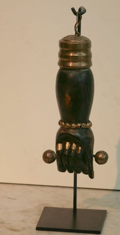 Beautifully carved Brazilian figa with brass fingernails, bracelet and ornament on<br />
newly made steel stand