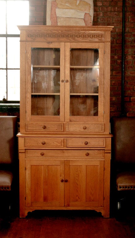 This very nice american pine step back cupboard has a thin vetical profile. The design gives the piece a dramtic yet simple appeal. Originally painted this is now in the natural wood with a fine dry surface. The cupboard has much usable space as