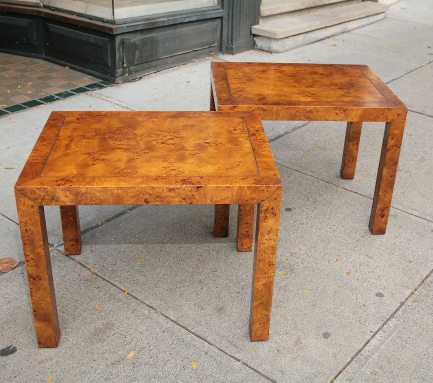 This beautiful pair of vintage end tables are crafted in Burled elm with a nice honey colored finish to bring out the dramatic wood grain. The parsons form of the tables a modern classic also gives the wood selection pride of place keeping the