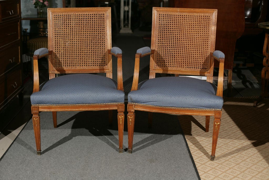 Pair of Cane Back Stamped Jansen arm chairs