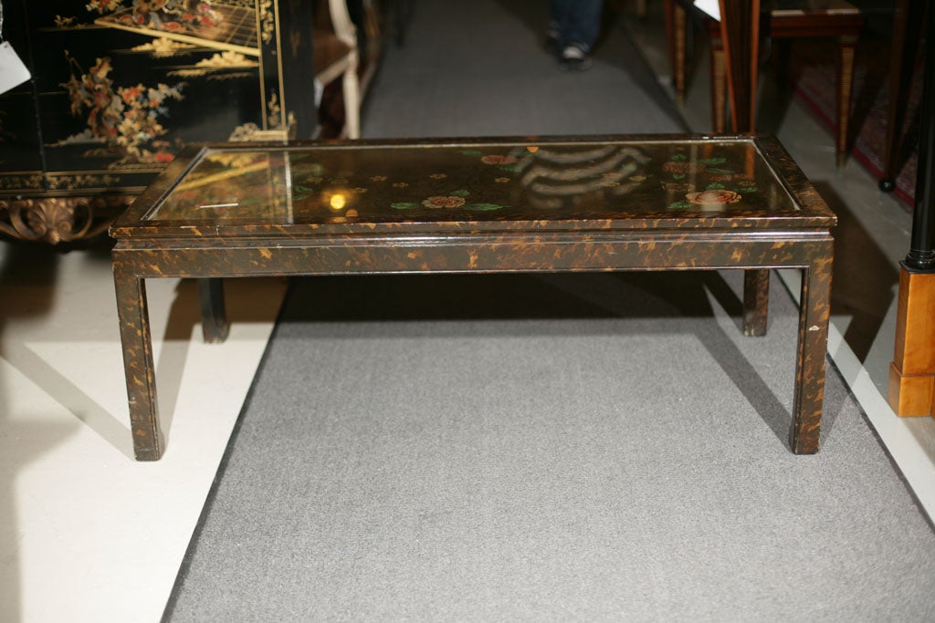 A faux tortoise painted rectangular coffee table with eglomise painted glass top, stamped Jansen.