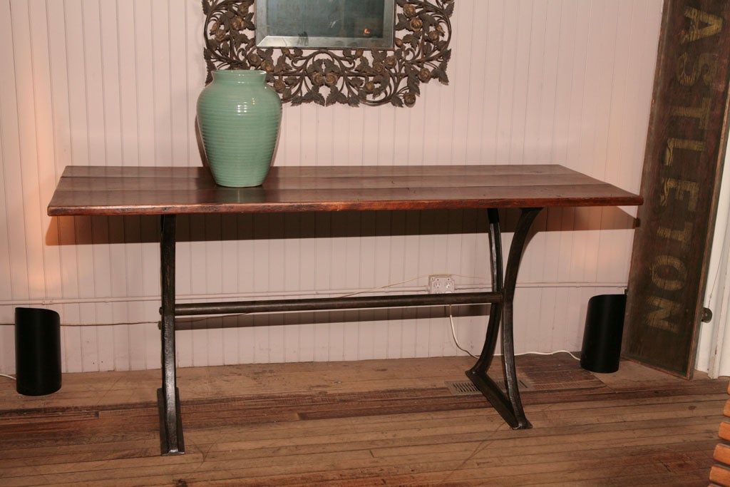 handsome tall console table<br />
three board splined mahogany top with beautiful patina<br />
supported by delicate cast iron trestle industrial base