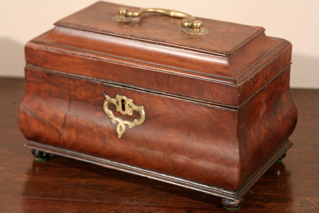 AN ANTIQUE ENGLISH, CHIPPENDALE, MAHOGANY BOMBE' FORM TEA CADDY, INTERIOR WITH 2 COVERS AND PLACE FOR MIXING BOWL, RETAING ITS' ORIGINAL HARDWARE AND IN WELL FIGURED VENEERS, EXCEPTIONAL COLOR AND FIGURE<br />
DATING CIRCA 1770