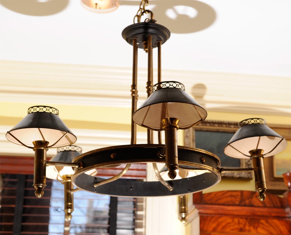 Five-arm brass and tole chandelier, with brass-and tole ring and tole shades on each arm.  Original paint on tole, which is a dark hunter green (not gray as it seems to appear in the photos).