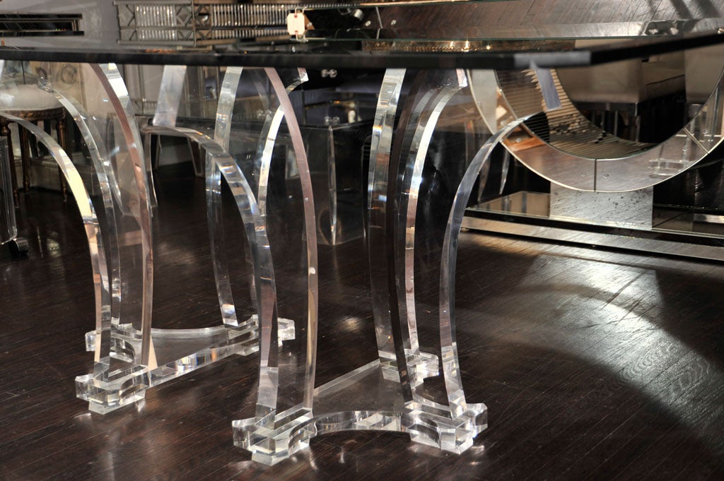 DINING TABLE WITH A PAIR OF LUCITE BASES AND A GLASS TOP