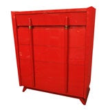 Red lacquered chest of drawers with brass detail