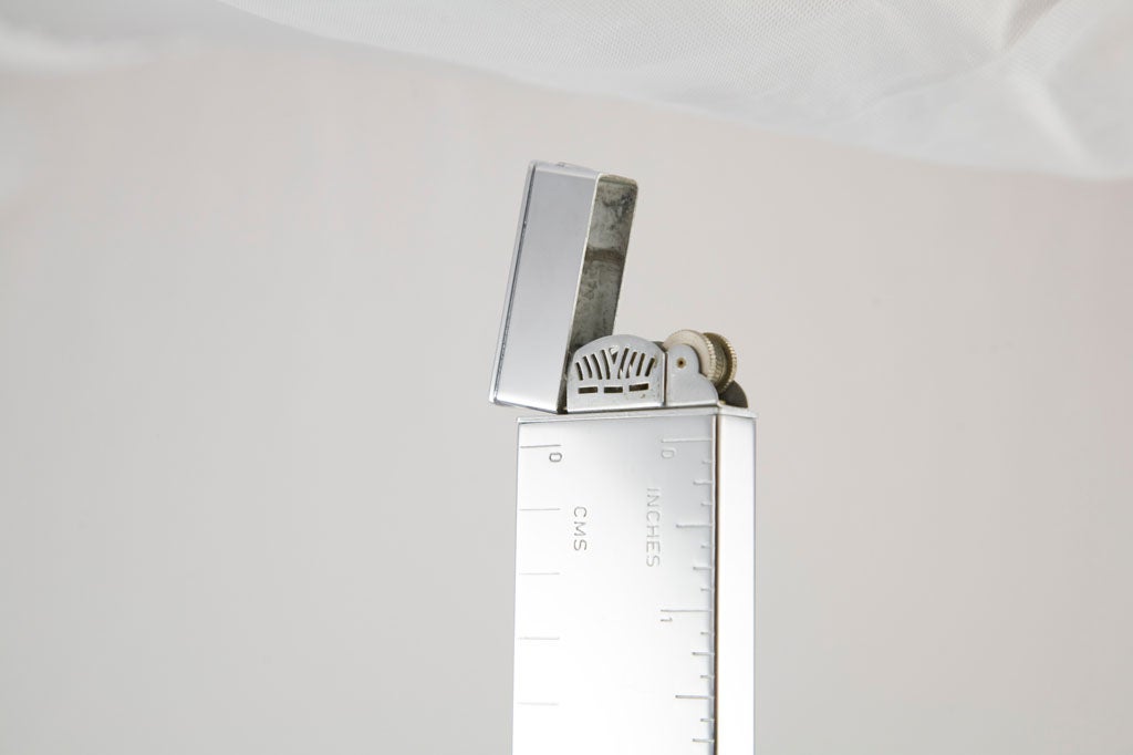 We are offering the perfect Christmas gift for the interior designer with everything!  This gorgeous foot-long polished chrome ruler doubles as a lighter.  The photos do not do this handsome piece justice.<br />
<br />
As you can see in the