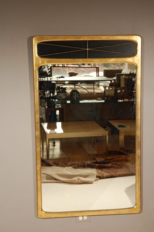 Large rectangular gold-leafed mirror with starburst pattern.